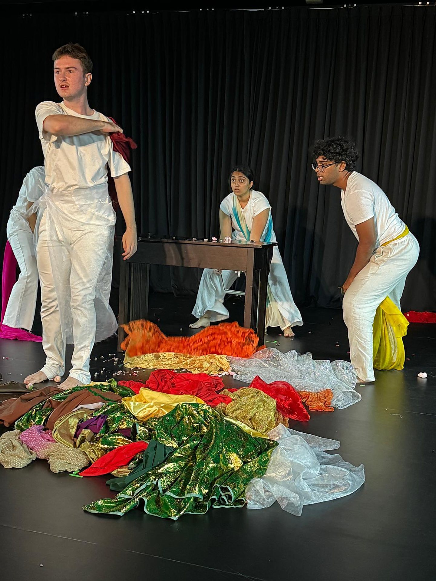 Ensemble in white over a floor of coloured fabric