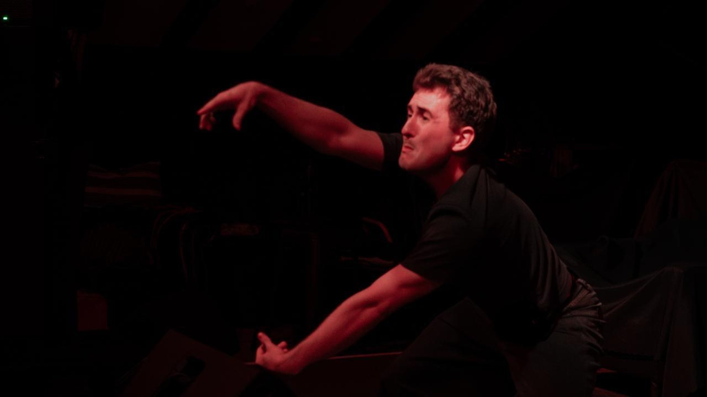 Andrei reaching into red light in Unbecoming