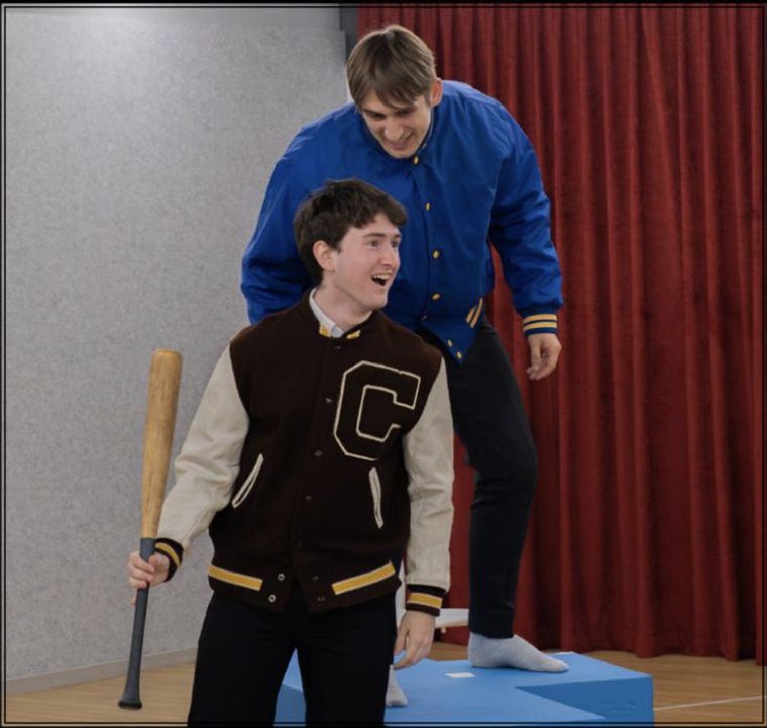 Andrei in a letterman jacket with a baseball bat in Our Town